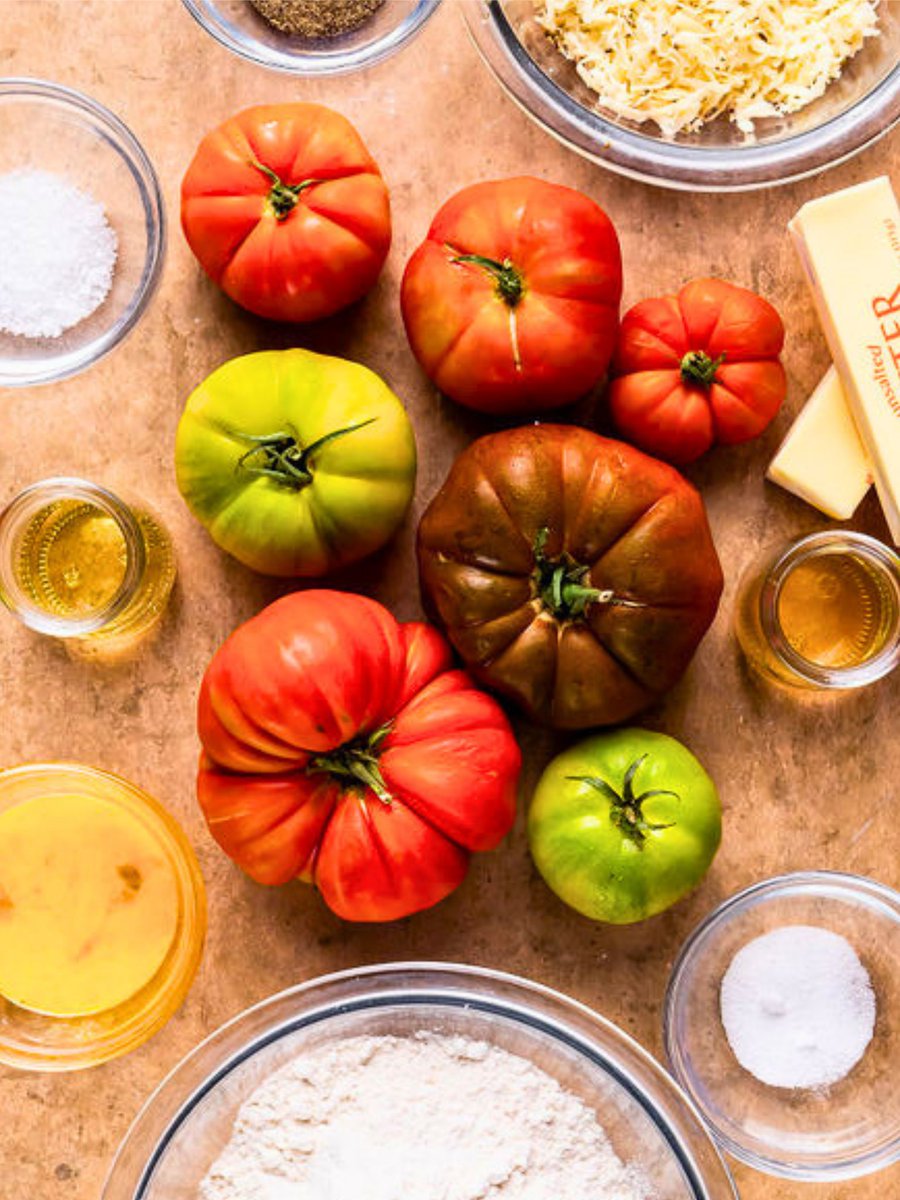 Tomato Galette 😍🍅 The tomatoes are roasted to perfection and lay over a bed of salty, rich cheese. The flakiness of the homemade crust combined with the sweetness of ripe heirloom tomatoes create the perfect shareable dish. justapinch.com/recipes/side/o… #summerrecipe  #farmtotable