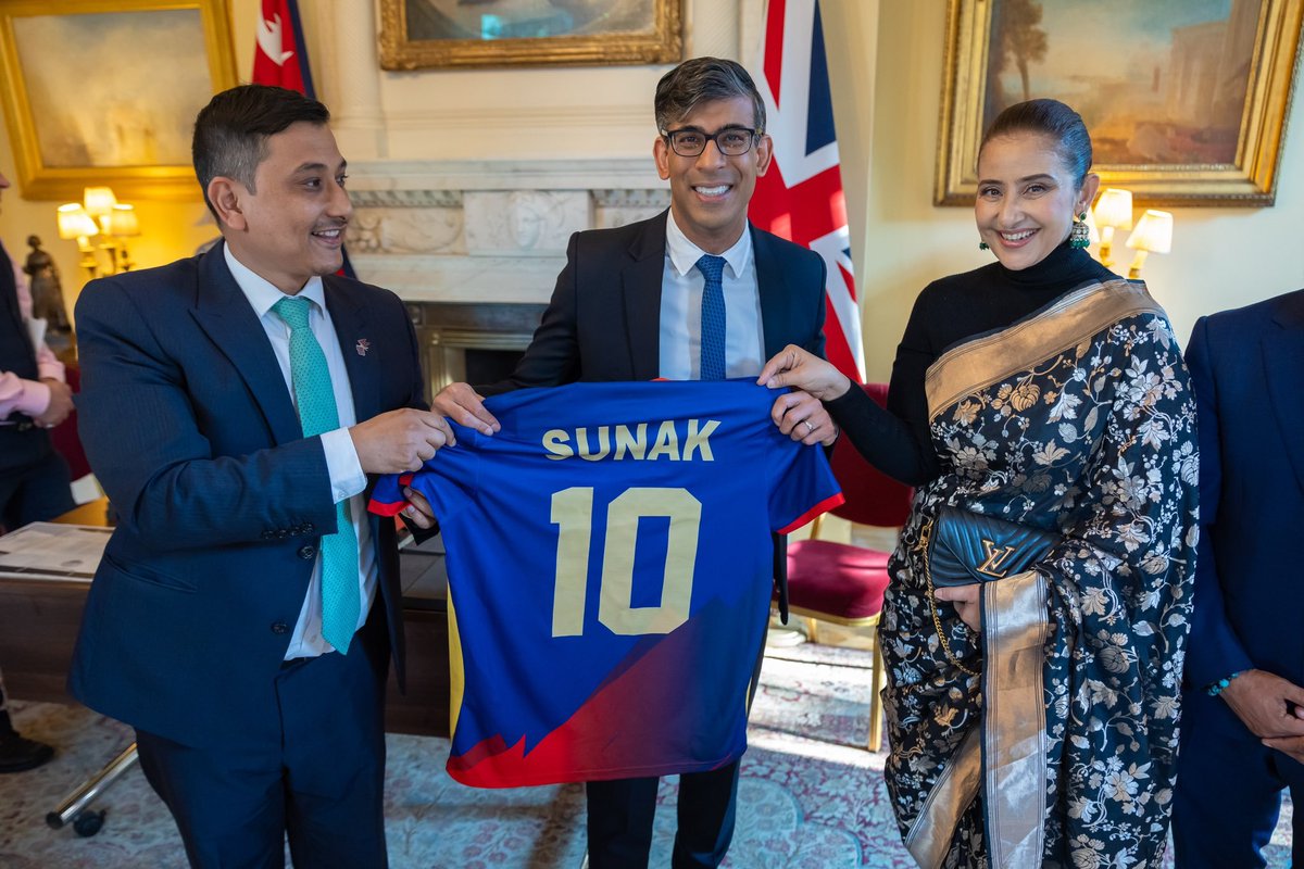 United Kingdom Prime Minister Rishi Sunak holding T20 World Cup Jersey of Nepal along with Manisha Koirala & Prashant Kunwar🔥🔥 📷: Internet #Nepal #T20WorldCup #England #CricketTwitter