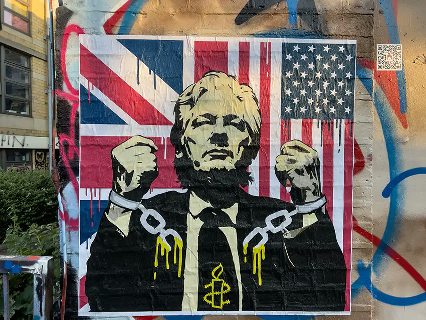 'Melt the Chains' poster near Brick Lane in London. Italian street artist Laika travelled to London to dedicate his new work to Julian Assange. #FreeAssangeNOW