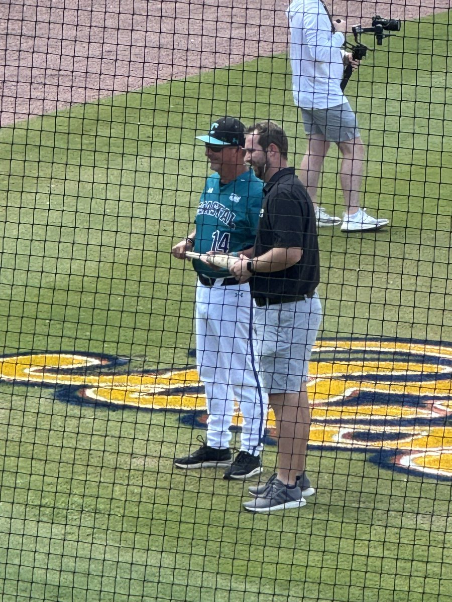 Coach Gilmore is presented with a bat signed by all other 13 Sun Belt Head Coaches.