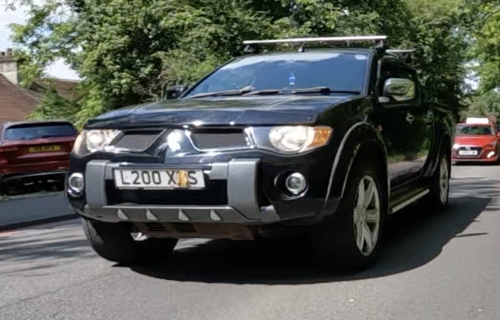 L200XGS
You shouldn't make it so obvious that you are covering your numberplate on purpose. And maybe try more than one character to make it harder to work out the missing letter. Only one other black Mitsubishi matches L200X?S. That vehicle is a different spec to yours.