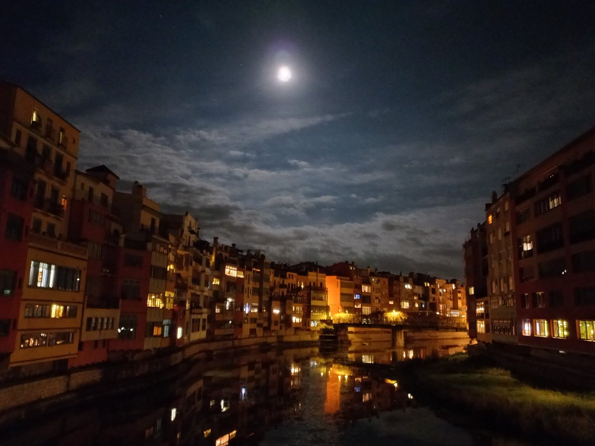 Una flassada de lluna
abriga de llum les cases.
Les formes es dilueixen
en ombres de tinta negra
a punt per dibuixar,
en embastes maldestres,
contorns de ciutat dormida
gronxada d'aigua i miralls. 

Girona, pedra i empenta:
enamorada...,
sempre.