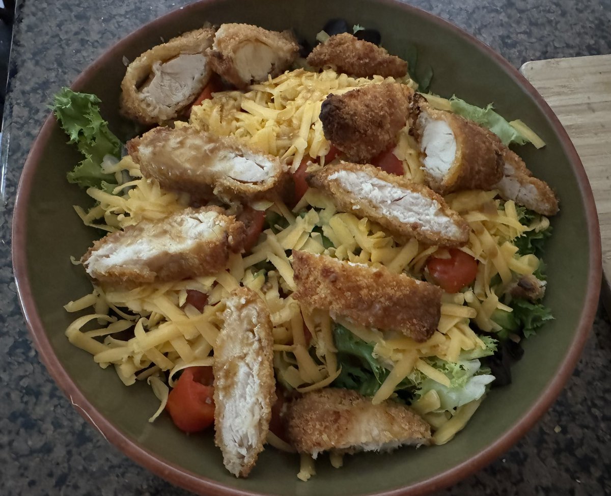 #may21familyfoodnight I love chicken tenders, Chick-fil-A if possible, Wendy’s or McDonald’s….so here is my upgraded chicken tender dish, healthy? Air fried panko coated tenders over a salad of mixed greens, cucumber, tomato and shredded cheese with a balsamic vinaigrette…