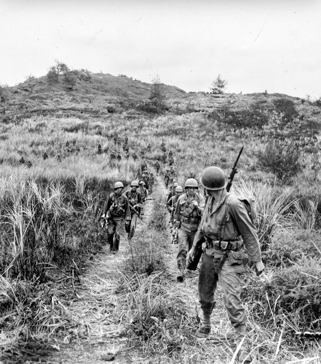 In July of 1944, soldiers of the 77th Infantry Division move out from high ground in search of the enemy on Guam. 🪖