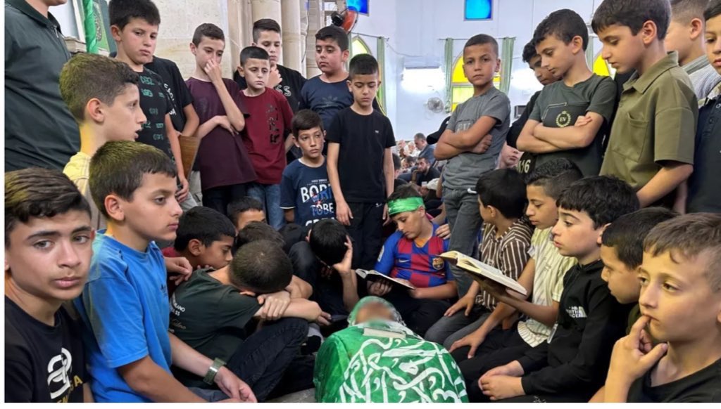 Children in Jenin paying their respects and praying near their teacher Allam Jaradat after the Israeli occupation murdered him when invading yesterday. West Bank