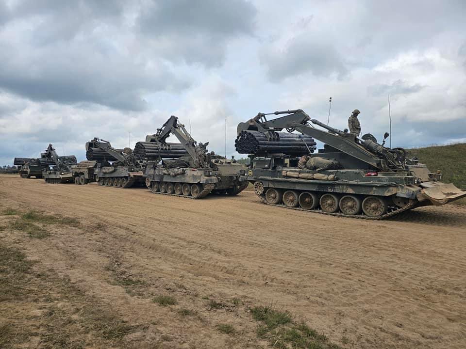 ArmouredSapper's tweet photo. Trojan AVREs operating alongside our NATO allies during a recent exercise in Poland. 

The Trojan AVRE is the @3rdUKDivision’s primary breaching vehicle for complex armoured obstacles and minefields. 

Armoured Sappers enable the Warfighting Division to Live, Move and Fight. 🦾 https://t.co/RvPSItVPcT