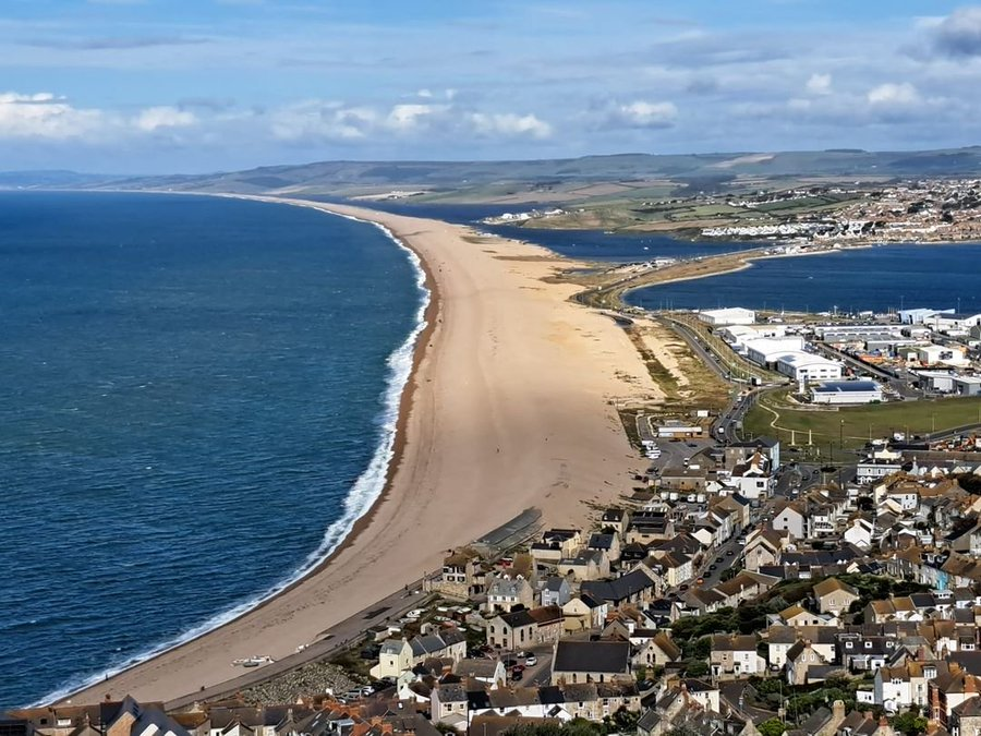 What a view! Chesil Beach is a tombola (a spit joined to the land at both ends) which stretches for 18 miles! Portland is a tied island connected to the mainland by #chesilbeach #portlandbill I took this pic from near the Olympic rings sculpture @VisitDorset @VisitDorsetBiz