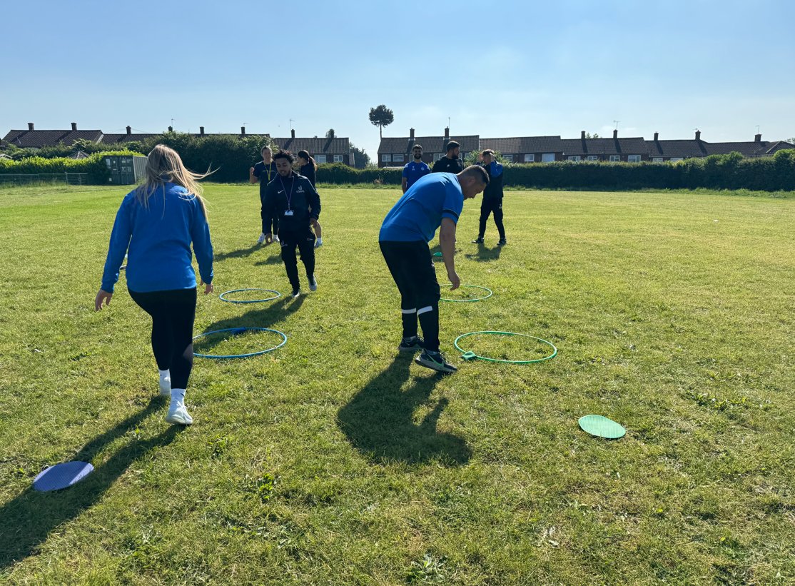 The P.E. team having some CPD time adapting and experimenting with new games for sports day.