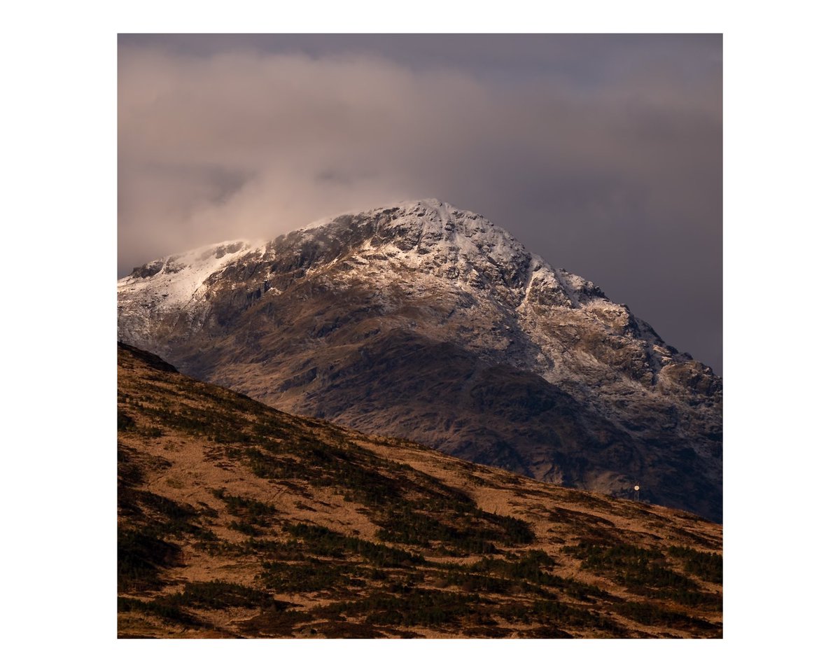 Captured this breathtaking view in the Trossachs, Scotland. The majestic peak, dusted with snow, stands tall against a dramatic sky. The serene beauty of nature here is simply awe-inspiring. #Scotland #Trossachs #NaturePhotography #Travel