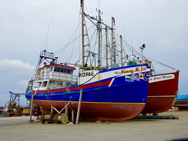 These fishing boats are really much larger than they look when they are in the water.