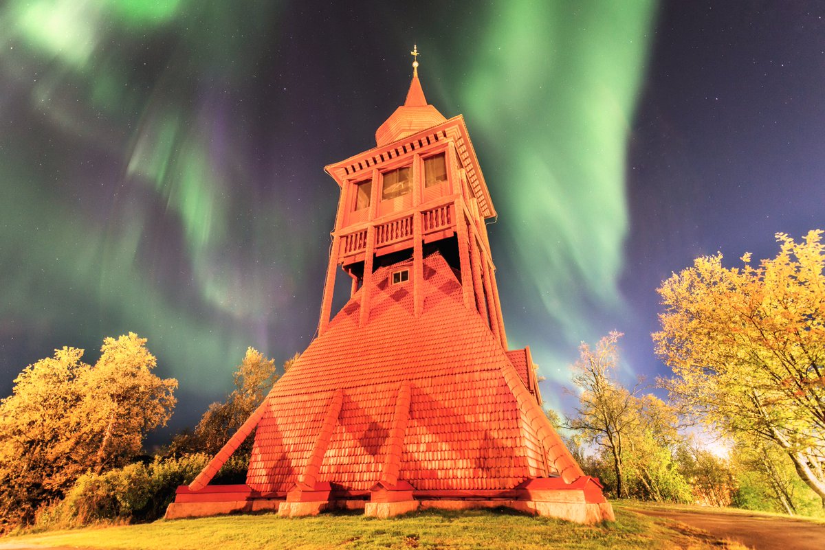 Autumn aurora by the Kiruna church. 
The famous wooden church and this bell tower will be moved to New Kiruna this summer. 
Quite the project!