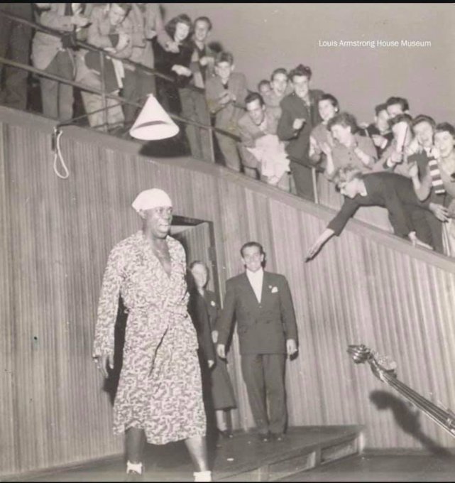 Louis Armstrong after a concert in Denmark in 1955.
The crowd wouldn't let him go, so he kept on coming out to take bows until he finally came out one last time in his bathrobe.