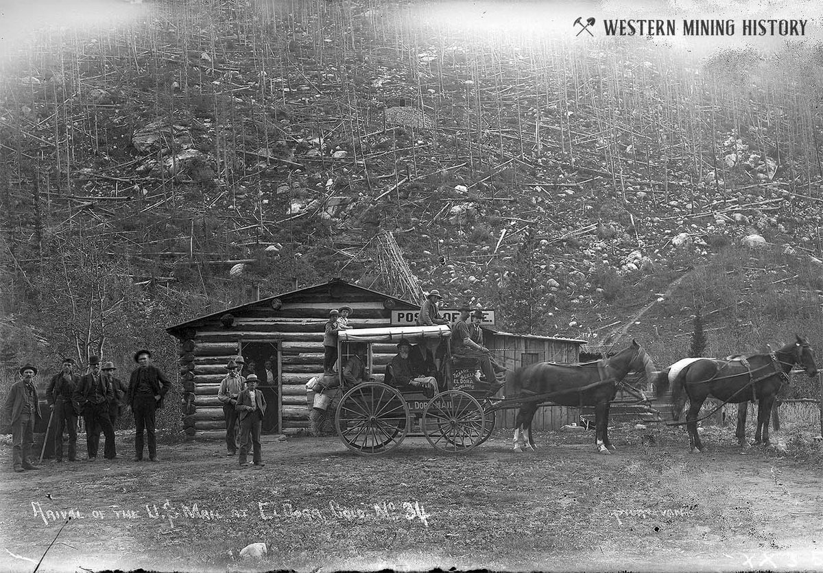 Arrival of the U.S. mail at Eldora, Colorado ca. 1897. Note the mine on the mountain behind the log post office.