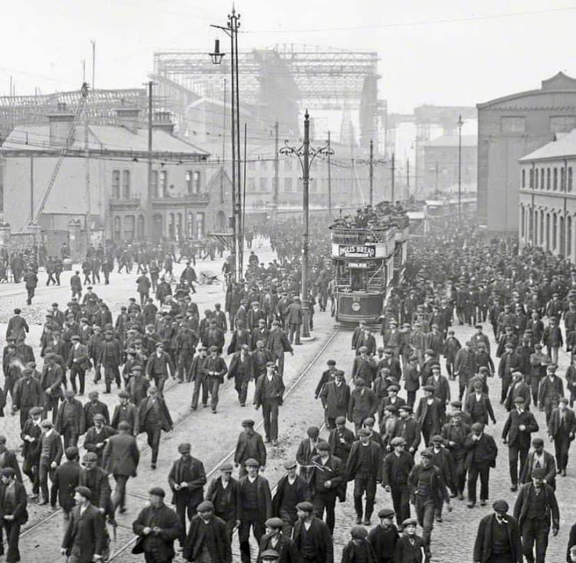 The workers at Harland & Wollf Shipyard in Belfast. 1911. The Titanic is in the background, a year before it is launched. Setting sail on the 10th April 1912 from Southampton to New York, the Titanic sank days later…