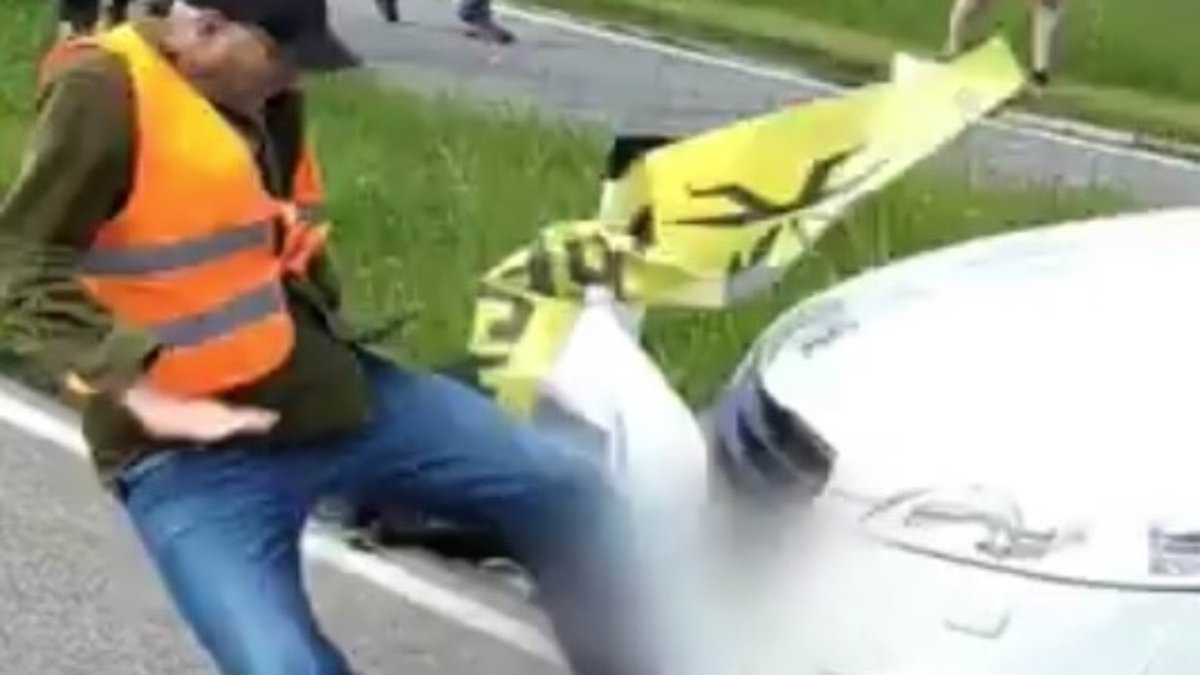 Road rage! Fed-up motorists run over eco-protesters, drag them off the street and leave them crying on the floor as they attempt to block traffic in Austria trib.al/hSzIDm8