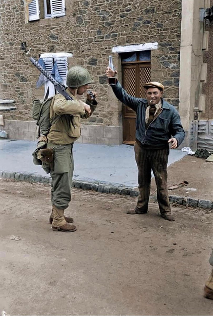 In July of 1944, a French resident offers a glass of wine to an American soldier in Périers, France. 🪖