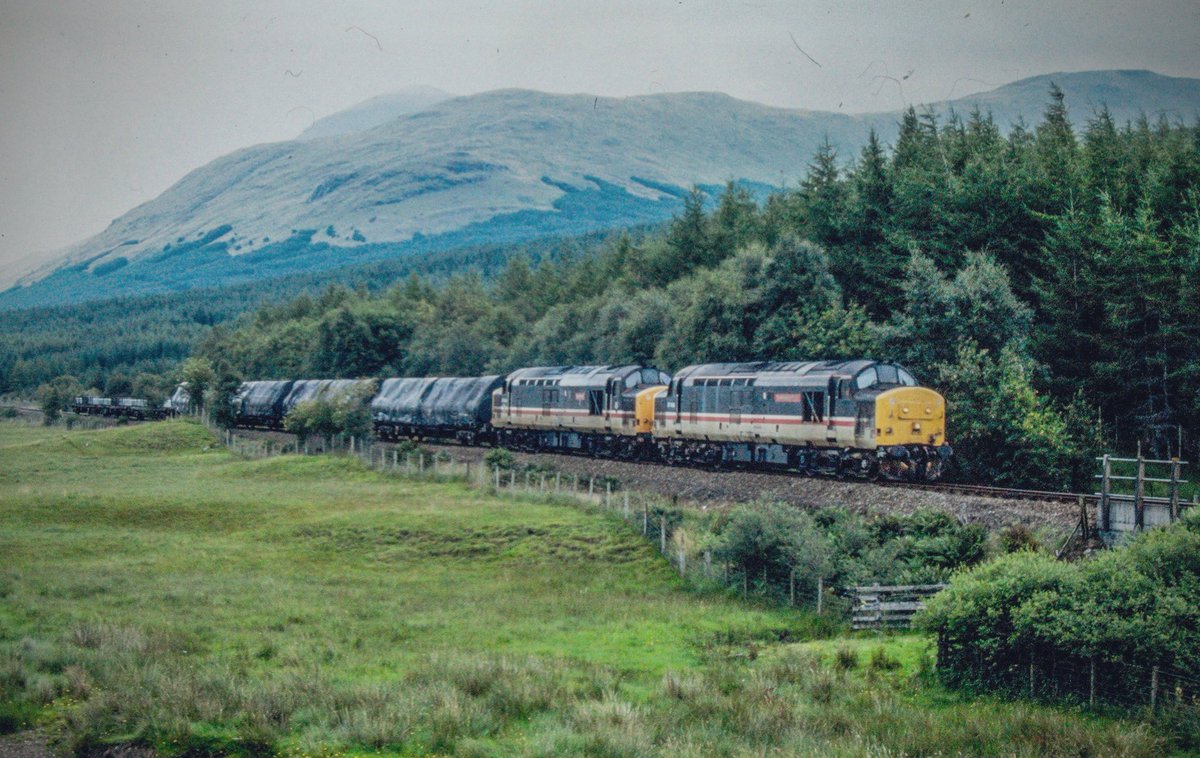 There’s a rumbling in the Glen, as 37406 ‘The Saltire Society’ and 37430 ‘Cwmbrân’ head south from Crianlarich with the Fort William to Mossend freight. A much missed working on the WHL. 
#Class37 #Tractor #WestHighlandLine #Crianlarich #BritishRail #Trainspotting