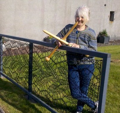 womensart1's tweet photo. Knitter Anne Eunson, who knitted a fence with twine based on a Shetland lace pattern, installed at the Shetland Textile Museum, Lerwick #WomensArt https://t.co/efB94Y7bc8