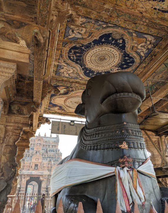 Standing tall in the historic city of Thanjavur, the Brihadeeswara Temple is a masterpiece of Chola architecture and a UNESCO World Heritage Site. Beyond its architectural splendor lies a lesser-known mystery surrounding its colossal Nandi statue. Despite being carved from a