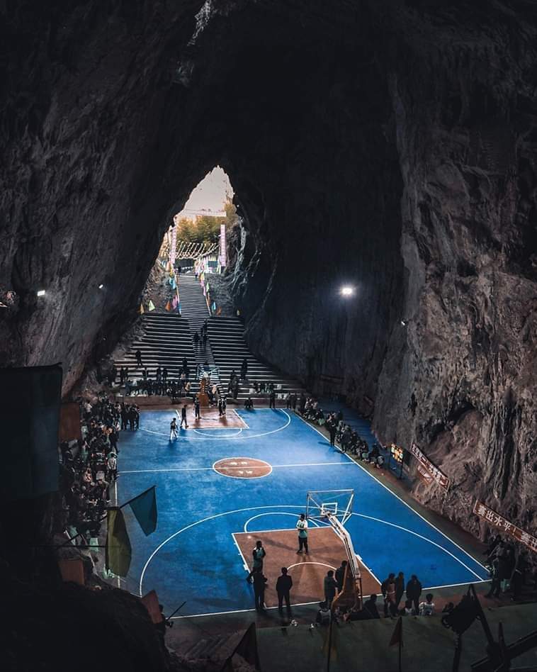 Basketball court built inside Karst cave in Guizhou, China. The basketball court measures 28 meters in length, with dimensions of 15 meters in width and length, occupying a total area of 1,000 square meters. Alongside the entrance, there are tiered seats capable of accommodating