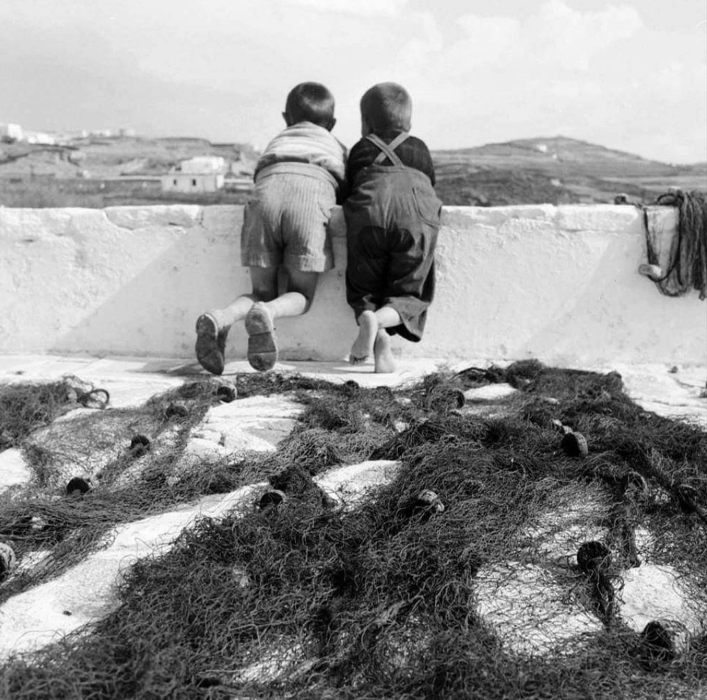 Two young boys sharing a tranquil moment on the Greek island of Mykonos, 1955. 🇬🇷 📷 Dimitris Harissiadis / Benaki Museum Photographic Archive.