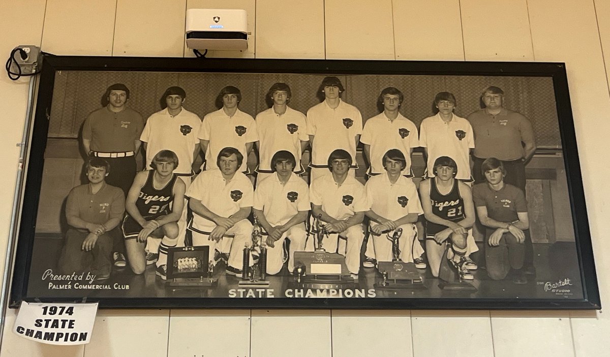 The 1974 Class D state champion Palmer Tigers from their great gym display of photographs. (Love how the placement of the Tigers' @Hudl Focus gives the impression that the old-timers are watching the current action closely!)