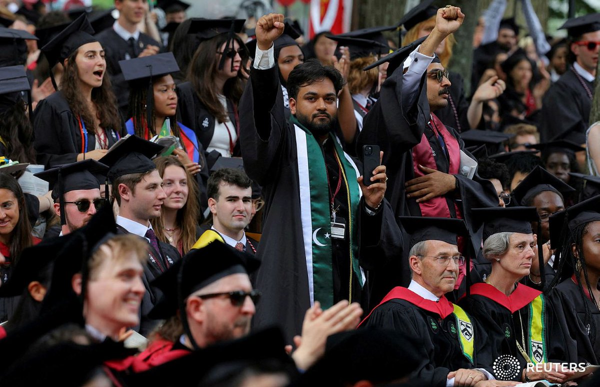 One of 13 students not able to graduate because they participated in pro-Palestinian protests raises his fist during the 373rd Commencement Exercises at Harvard University, in Cambridge, Massachusetts, U.S., May 23, 2024. REUTERS/Brian Snyder