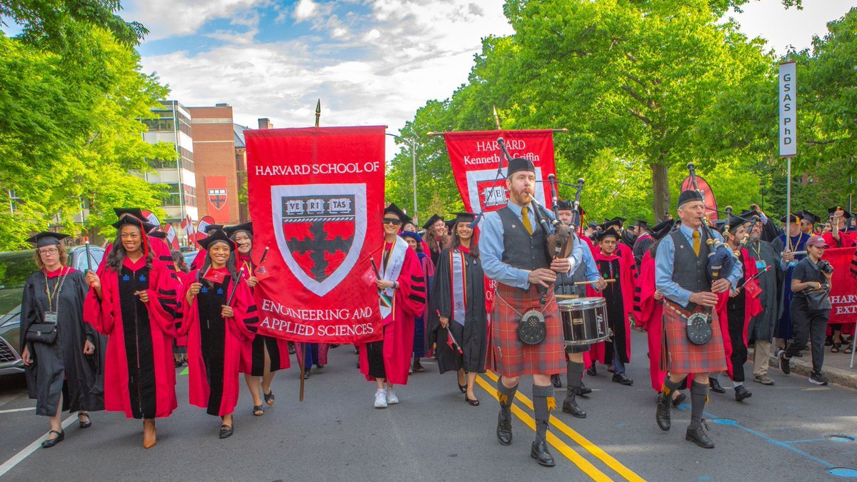 Marshals carry the SEAS banner down Oxford Street during the Procession at Commencement!
