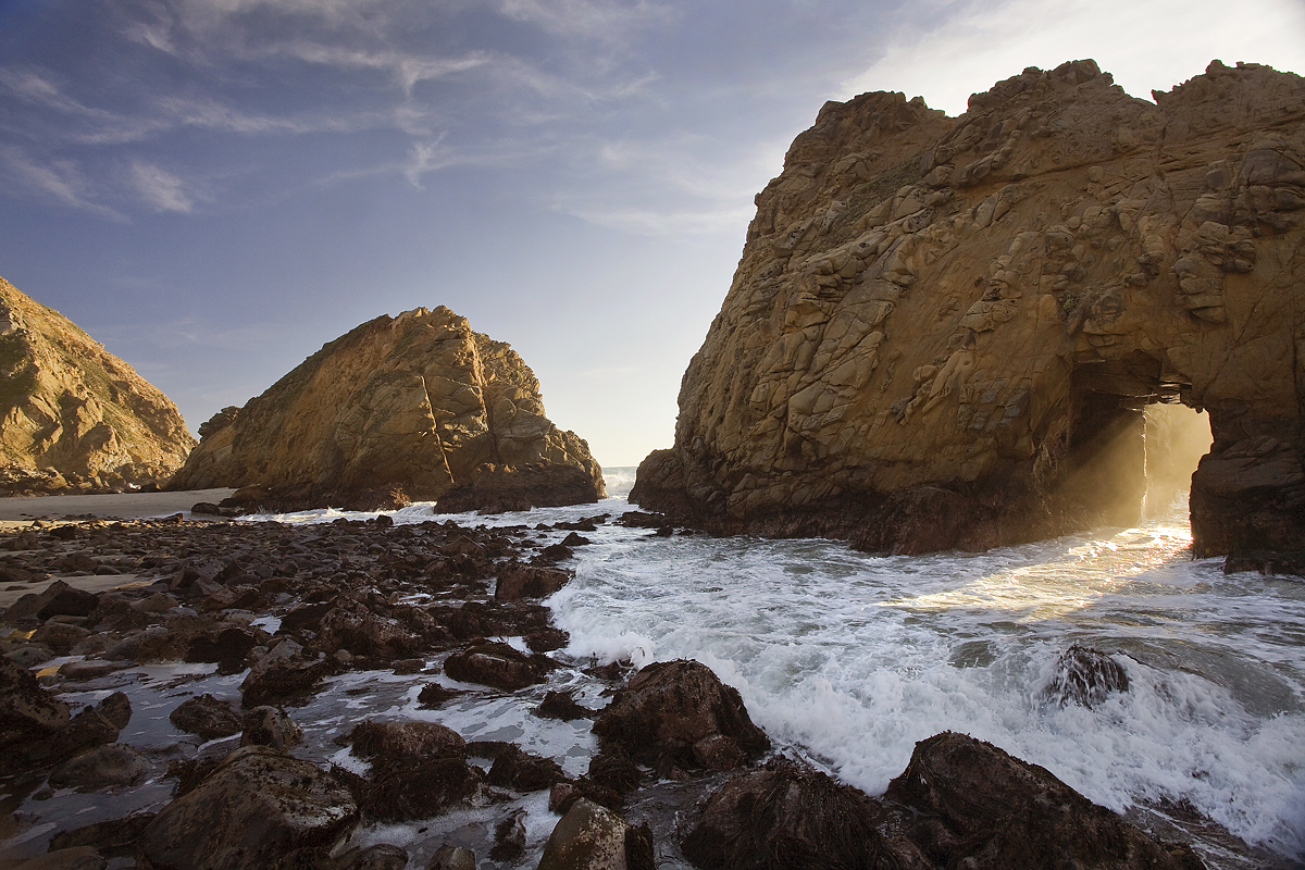 During your visit to Big Sur, catch the sunset at Keyhole Rock on Pfeiffer Beach, near Post Ranch. The stunning sky and coastline create an unforgettable experience. photography @kodiakgreenwood 
#postranchinn  #sierramarrestaurant #michelinhotel  #pfeifferbeach