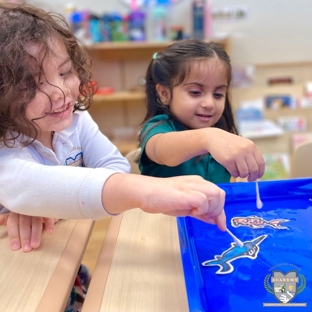 Our Primary class buddies are delving into science experiments during Fish Week. They discovered that adding dish soap to their foam fish would alter their swimming speed across the water. #MontessoriEducation #ReggioEmilia #EarlyChildhoodEducation #Cognia #HoustonsBest