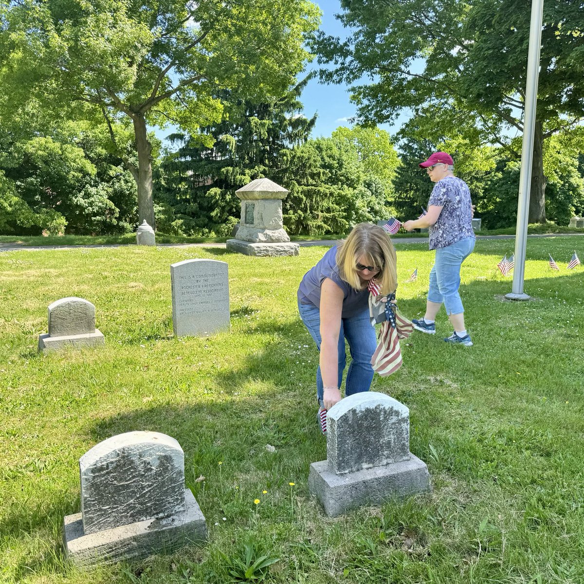 monroesheriffny's tweet photo. Our #dayofcaring cleanup effort at Mt. Hope Cemetery originated at the graves of firefighters laid to rest on these historical burial grounds. We humbly placed flags donated by ⁦@VOCROC⁩   on firefighters’ graves &amp; did the same for veterans. Thank you all for your service. https://t.co/jSEHDcuMXk