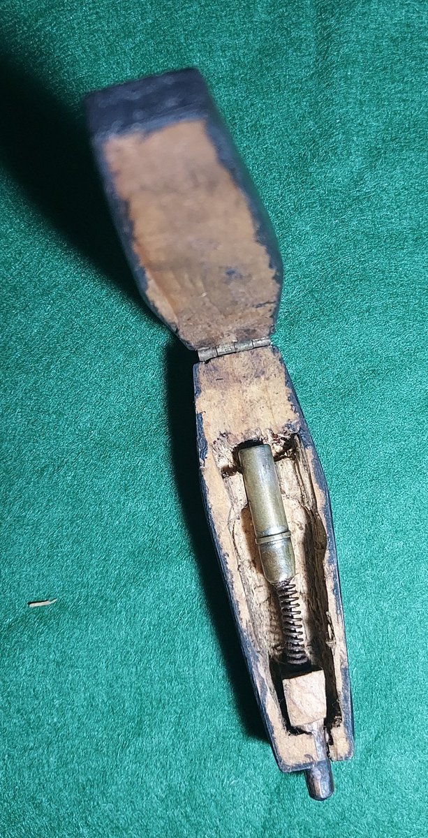 Any ideas what this might be? About 2 inches long. Shaped like a coffin. Tiny pin on spring. #nineteenthcentury #antiques #coffin #wood