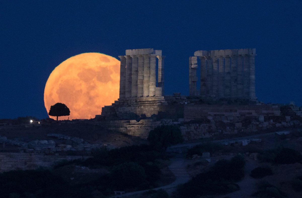 The full moon rises above the Ancient Temple of Poseidon at Cape Sounion, in Sounion, Greece, on May 22, 2024. #fullmoon
