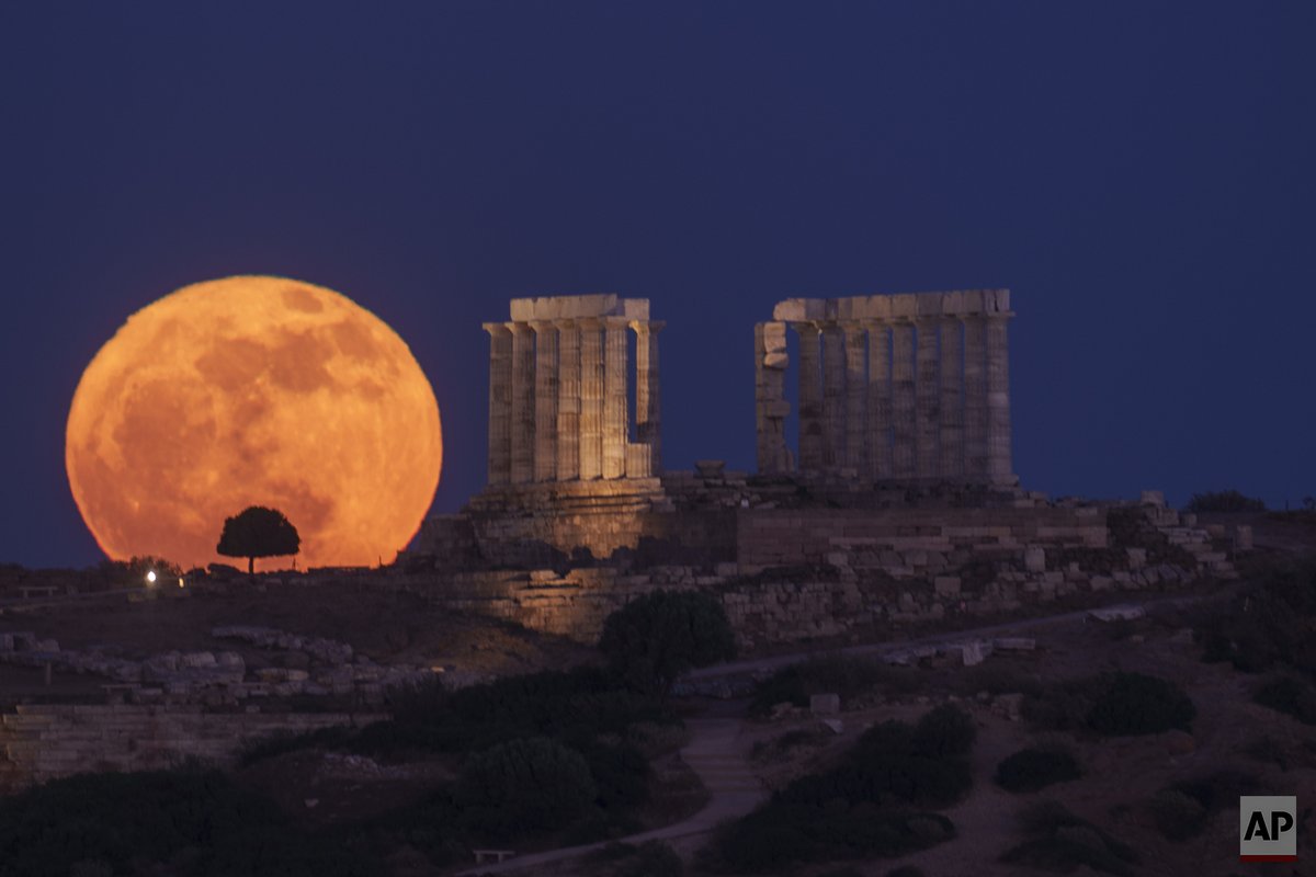 The flower moon rises behind a tree next  the ancient temple of Poseidon at Cape Sounion, south of Athens, Greece, on Thursday, May 23, 2024. 
<a href="/AP/">The Associated Press</a> /<a href="/PGiannakouris/">Petros Giannakouris</a> 
#greece