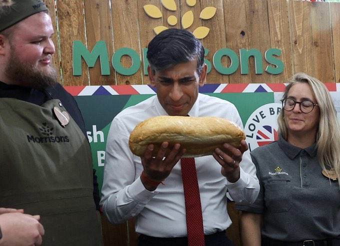 Woman on the right has everybody's reaction to Rishi Sunak sniffing a loaf of bread.
