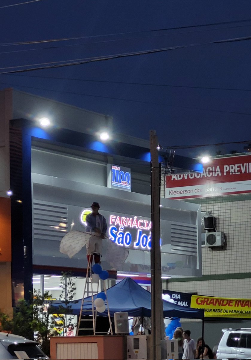 maluco em pé numa escada (que tá num muro) balançando e gritando. Palhoça é pika.