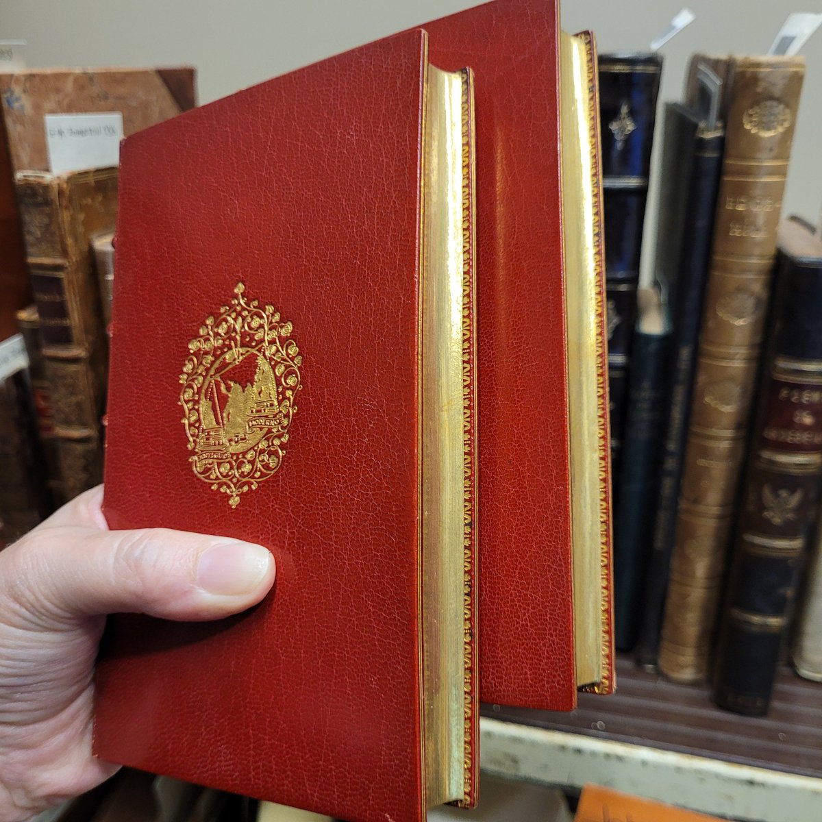On the cataloging truck today is the 2 volume set 'Premier et second thome des histoires tragiques,' published in 1568. The 19th-century crimson morocco binding by Chambolle-Duru is stunning! The supra-libros of Isidoro Fernandez are embossed in gold on the covers. #16thCentury