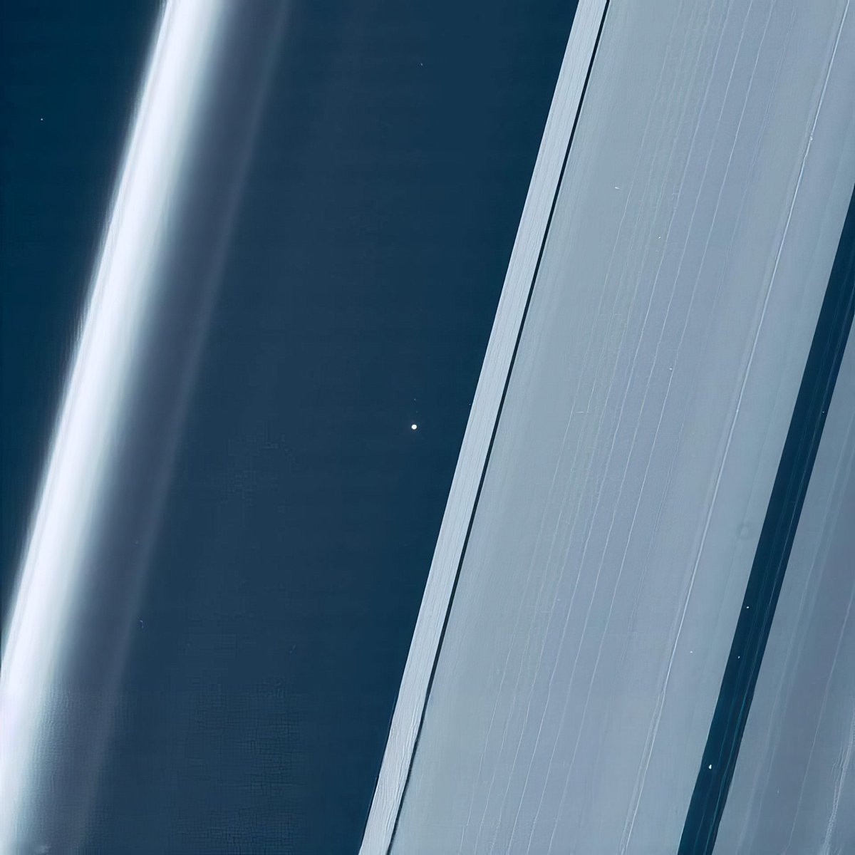 Earth and Moon between the rings of Saturn.