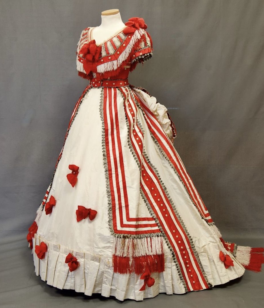 I hope that the wearer of this mid #1860s ballgown had her dance card filled and her pick of those who were left trailing in her wake. Not for her the plain monochrome gown, but a riot, a festoon of white and red #cohassethistoricalsociety #fashionhistory