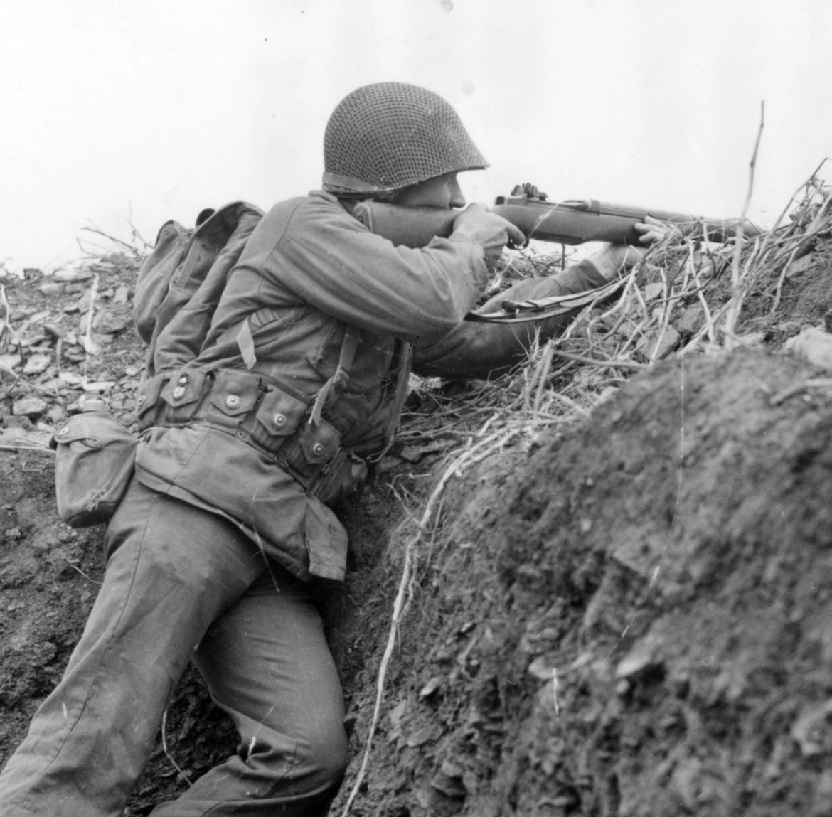 In October of 1944, Sgt. Justus Westover takes aim at the enemy from an observation in a trench along the German border. 🪖