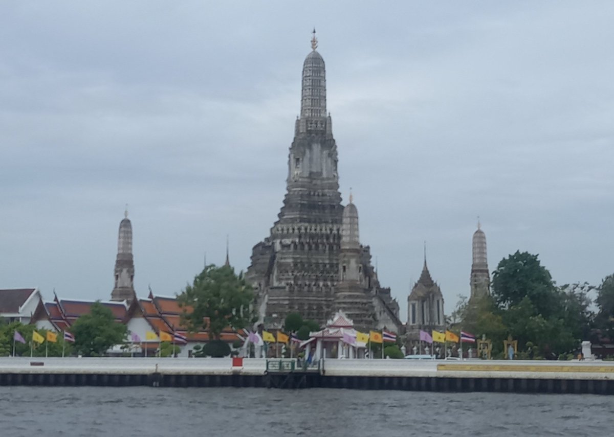 A riverfront scenery view of Wat Arun (Temple of Dawn) on Friday morning. Bangkok, Thailand