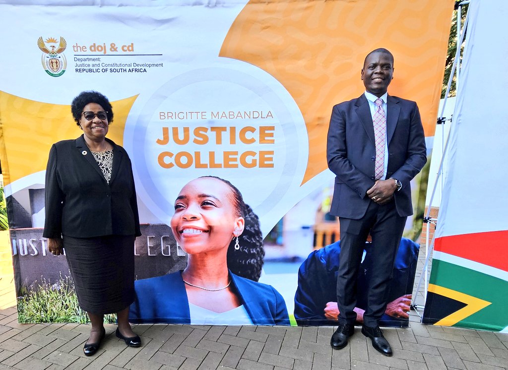 Minister @RonaldLamola poses with South Africa's first female Minister of Justice Ambassador Brigitte Mabandla with a backdrop bearing the name of the newly relaunched Brigitte Mabandla Justice College. #JusticeCollegeRelaunch