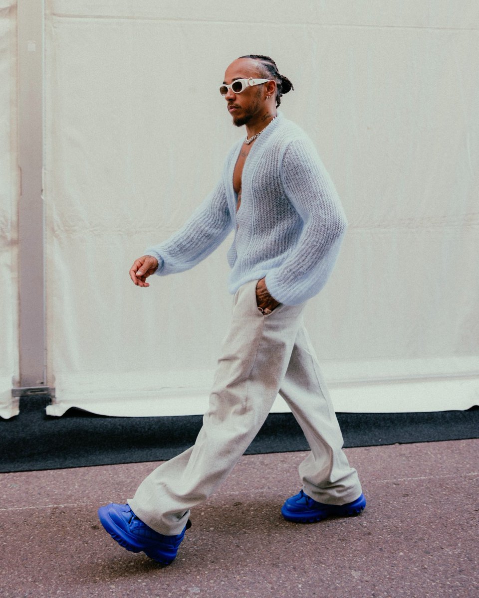 Dynamic contours. At the @F1 Grand Prix of Monaco, @LewisHamilton raced ahead in style with a custom Dior men's ensemble by Kim Jones, showcasing a plush light blue deep V-neck jumper and handcrafted indigo-dyed wide leg trousers. #StarsinDior #F1 #MonacoGP