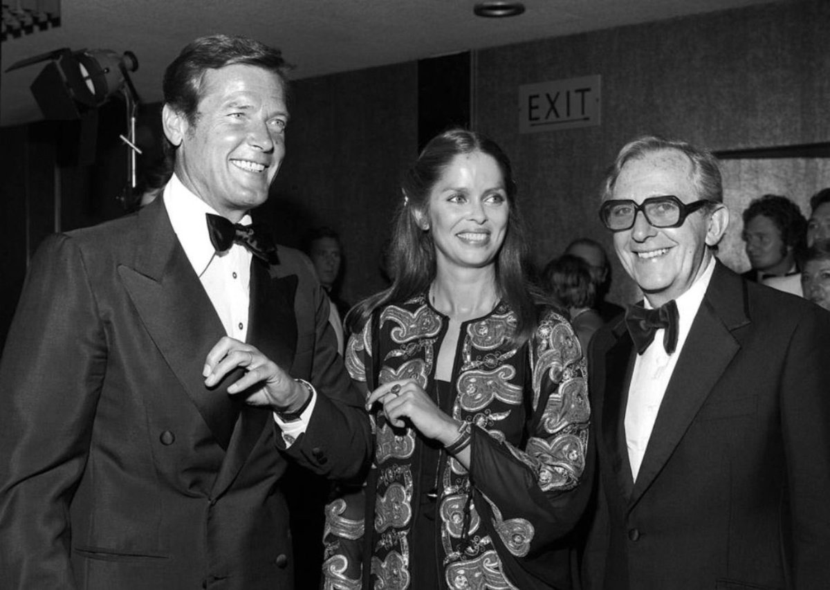 It’s the best date to be at the cinema! 7/7/77 and in Leicester Square, London - Roger Moore, Barbara Bach and Director Luis Gilbert are at the Odeon for #thespywholovedme premiere. #bond #jamesbond #rogermoore #barbarabach #lewisgilbert #colourised #colourized