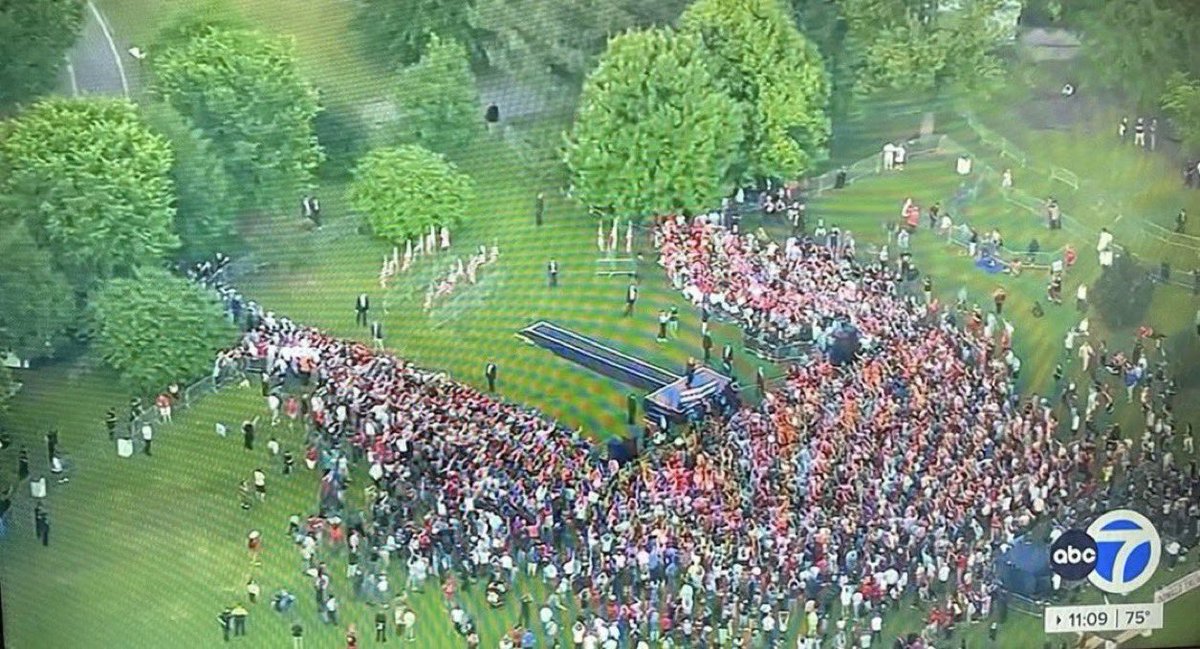 What’s funny about this photo is 1) the small size of the actual crowd; and 2) the really, really, really long ramp on a gentle incline leading up to the podium.