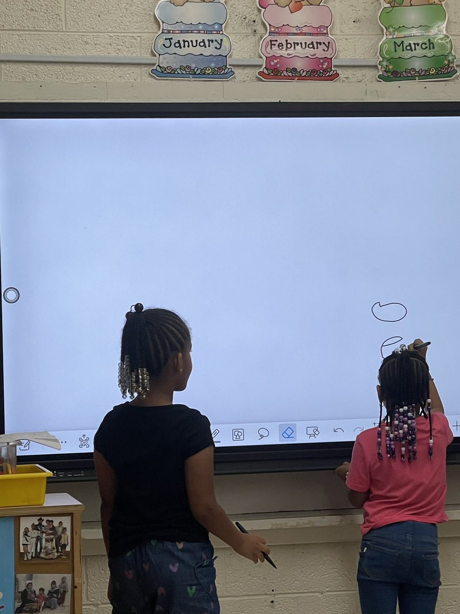 Mrs. Young working with Pre K on letters using the white board.