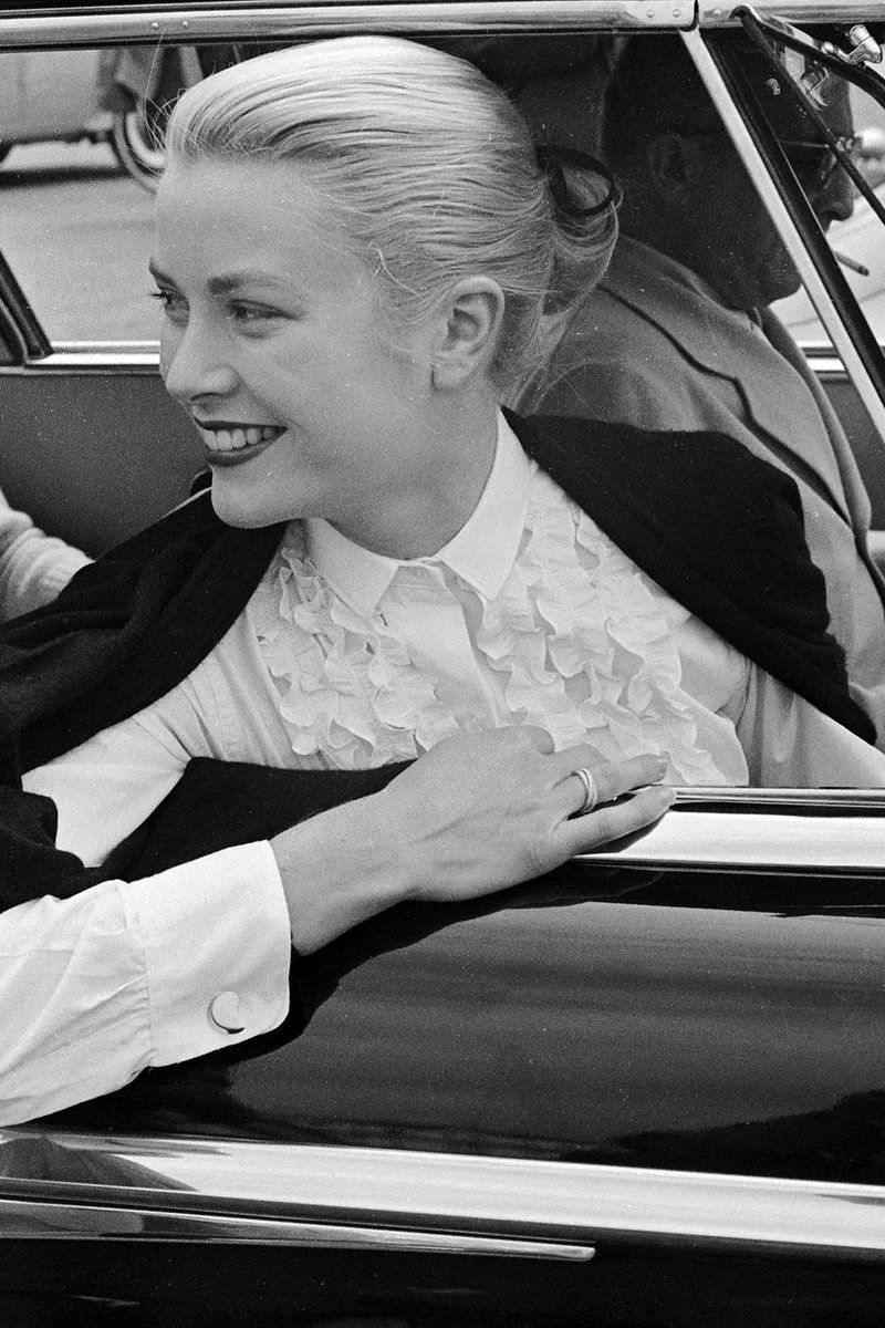 Grace Kelly pictured wearing her Cartier Trinity ring in 1955 which she wore on her fourth finger. The ring features three intertwined rose, white, and yellow gold bands. The three interlocking golden bands in three different colours symbolise love, friendship, and fidelity.