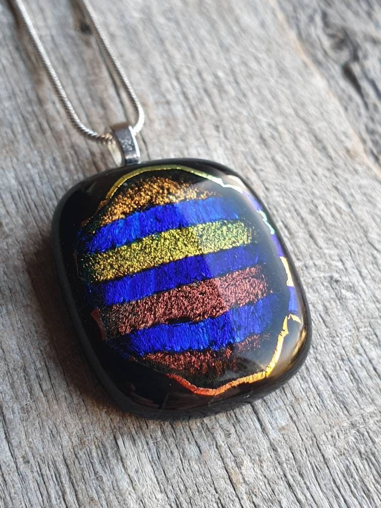 Amazing colours within this handcrafted dichroic glass pendant. Wonderful window within black glass with beautiful colours. #handmade #etsy #giftideas #shopindie #giftideas buff.ly/3NXCYsw