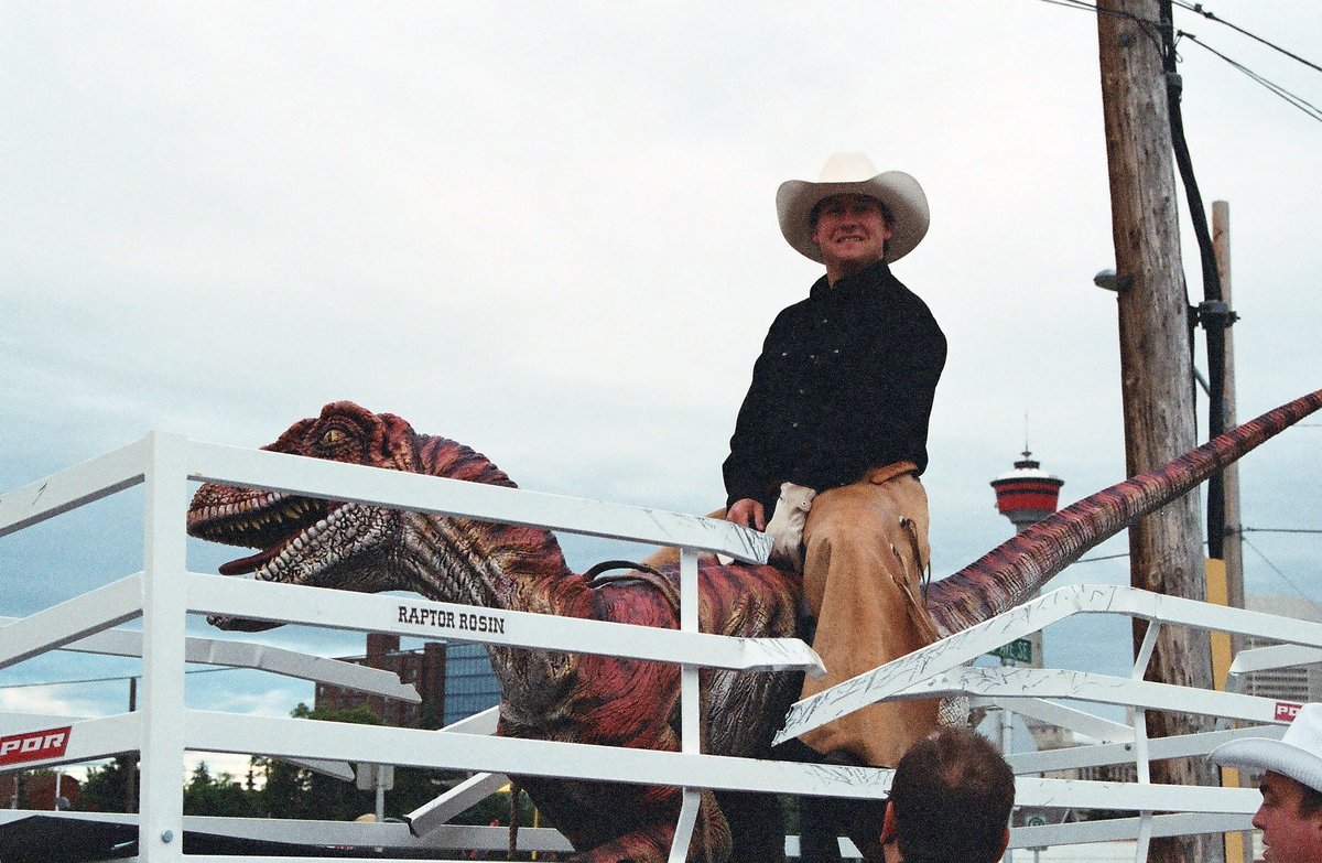 Our co-worker Tyler was the calmest raptor rider we’ve ever seen! #Throwback to our Calgary Stampede parade float entry in 2004. Would you last 8 seconds on a raptor? #FlashbackFriday