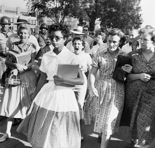 Elizabeth Eckford ignores the screams of students on her first day integrated into a Little Rock High School, 1957.